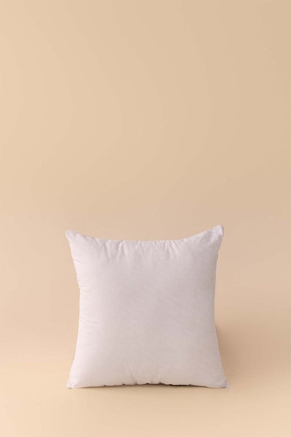 White pillow on a beige background