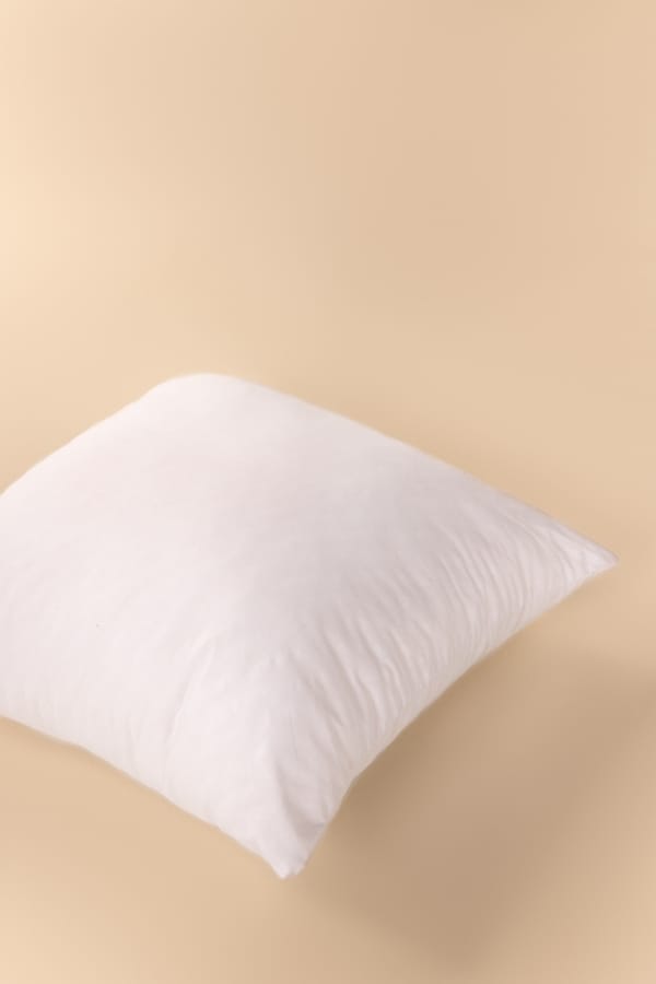 White pillow on a beige background