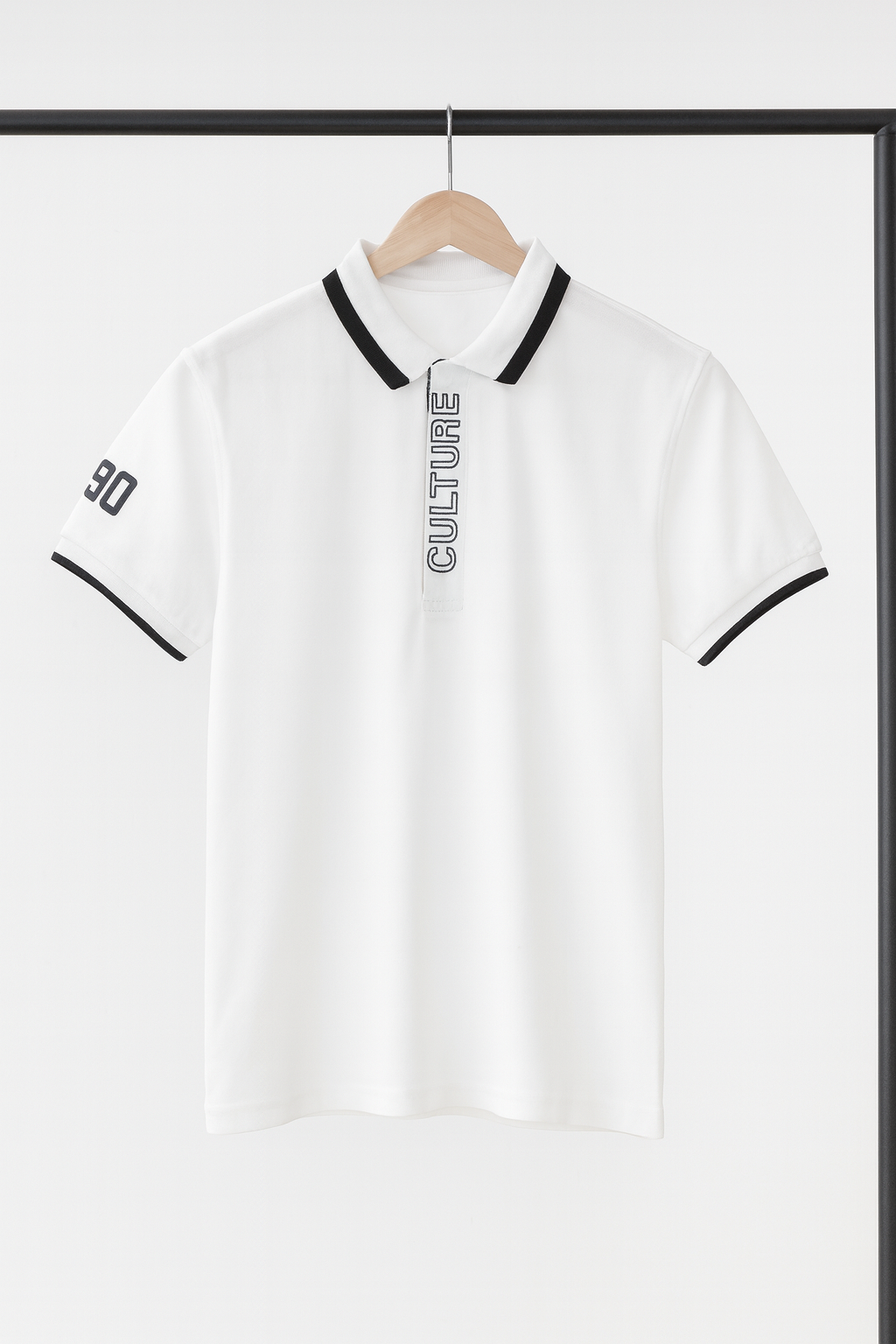 White polo shirt with black accents and 'CULTURE' text on a hanger against a white background