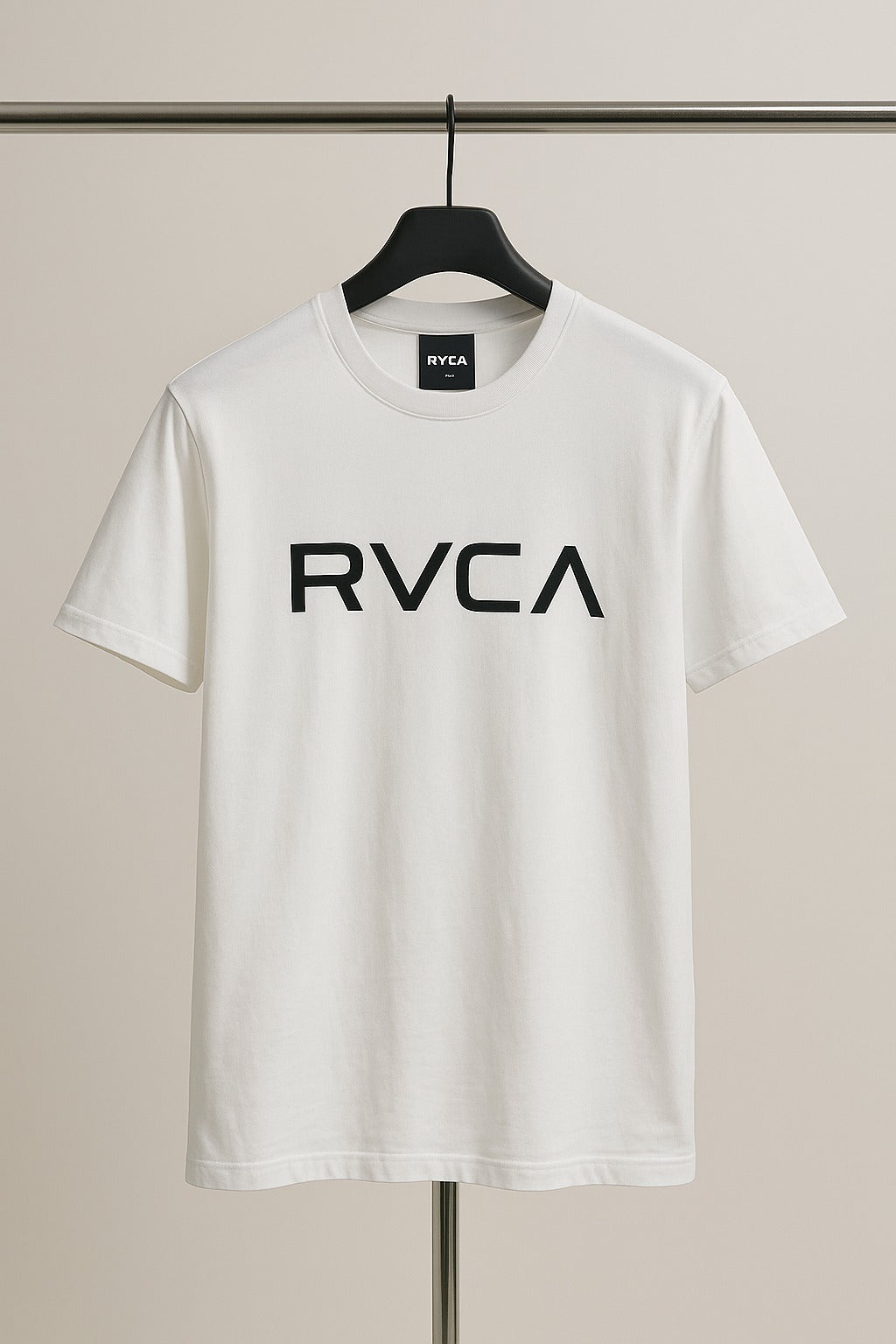 White t-shirt with 'RVCA' logo on a hanger against a neutral background