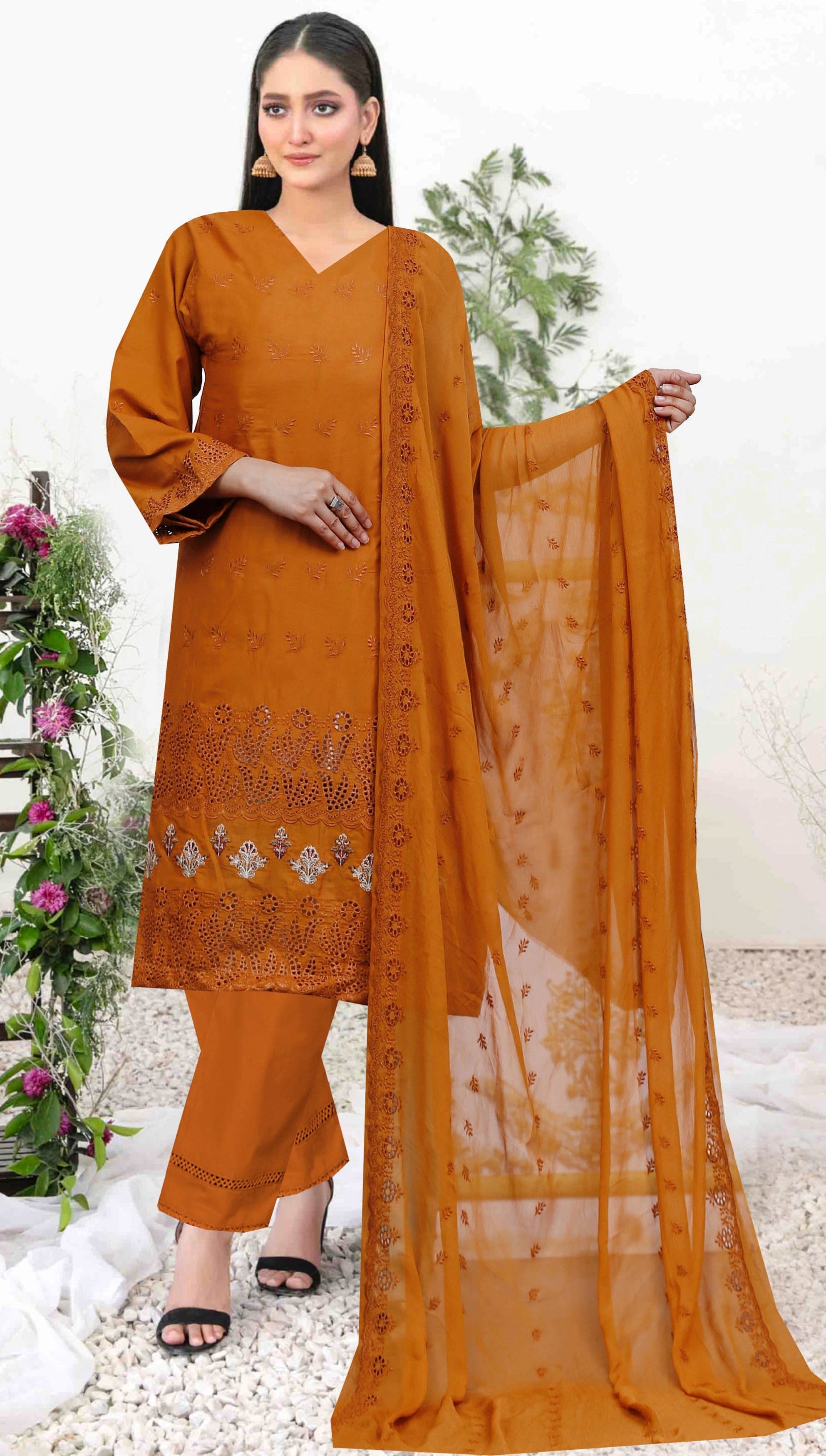 Woman holding a mustard yellow dupatta with floral patterns on a white background