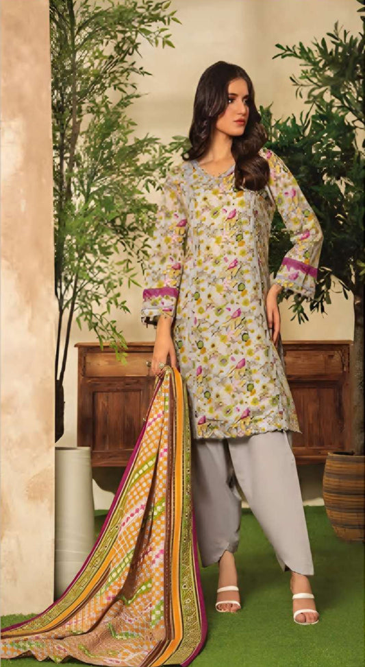 Woman in a floral dress holding a colorful dupatta with plants and a wooden cabinet in the background.