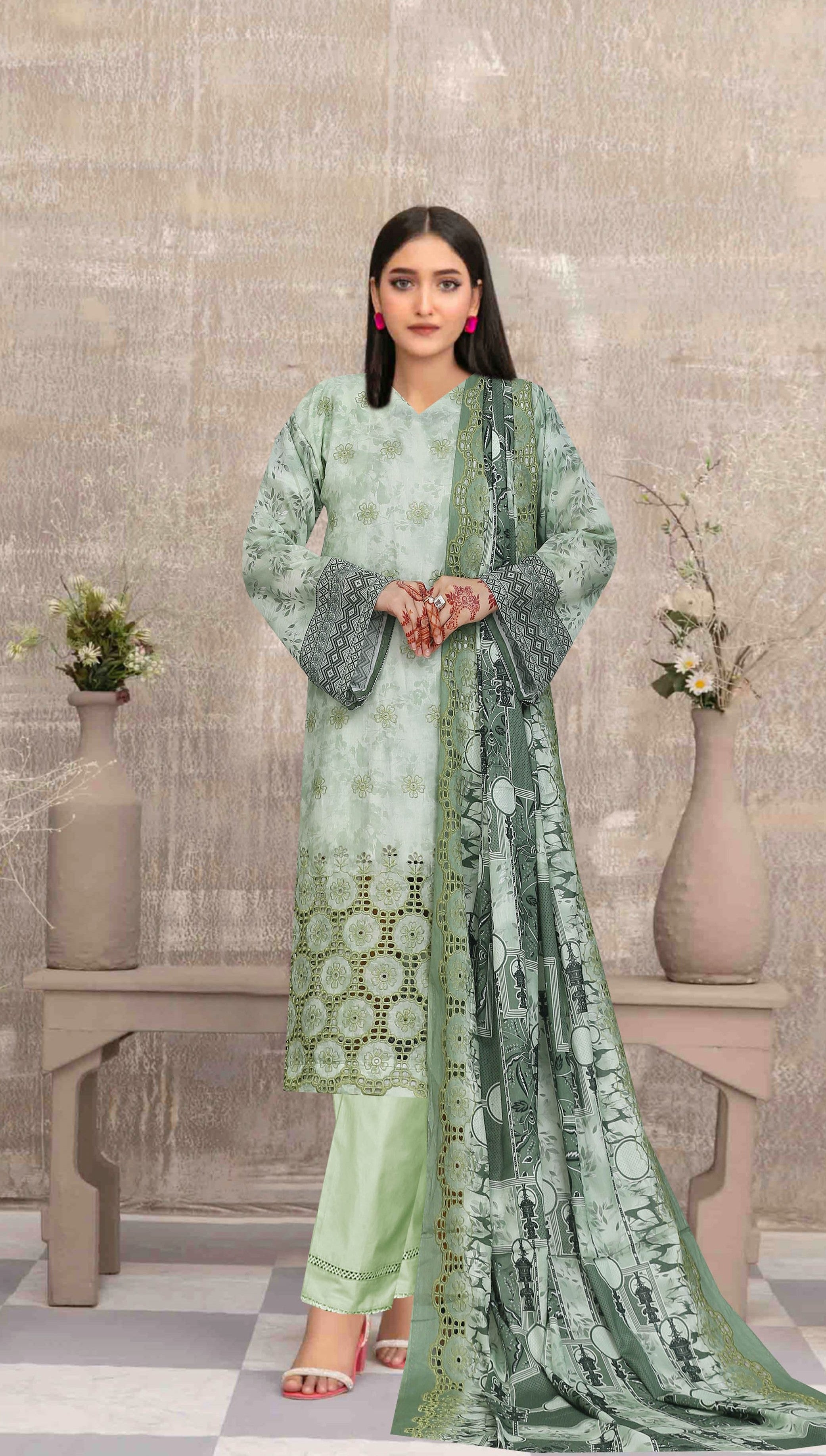 Woman in a green traditional outfit standing in a room with decorative elements.