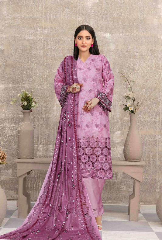Woman in a pink traditional outfit with a matching dupatta in a decorative setting.