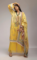 Woman in a yellow traditional outfit with a dupatta against a plain background