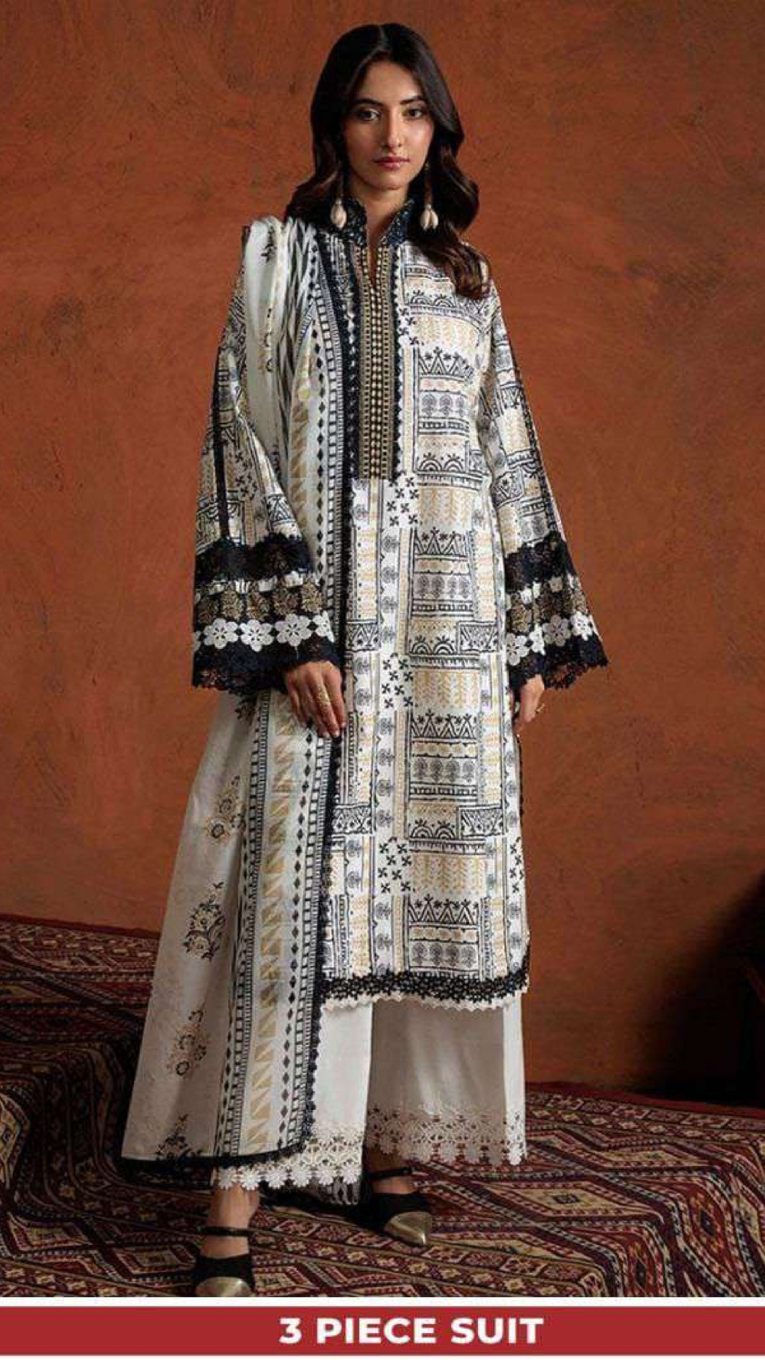 Woman wearing a 3-piece suit with a patterned design against a brown background