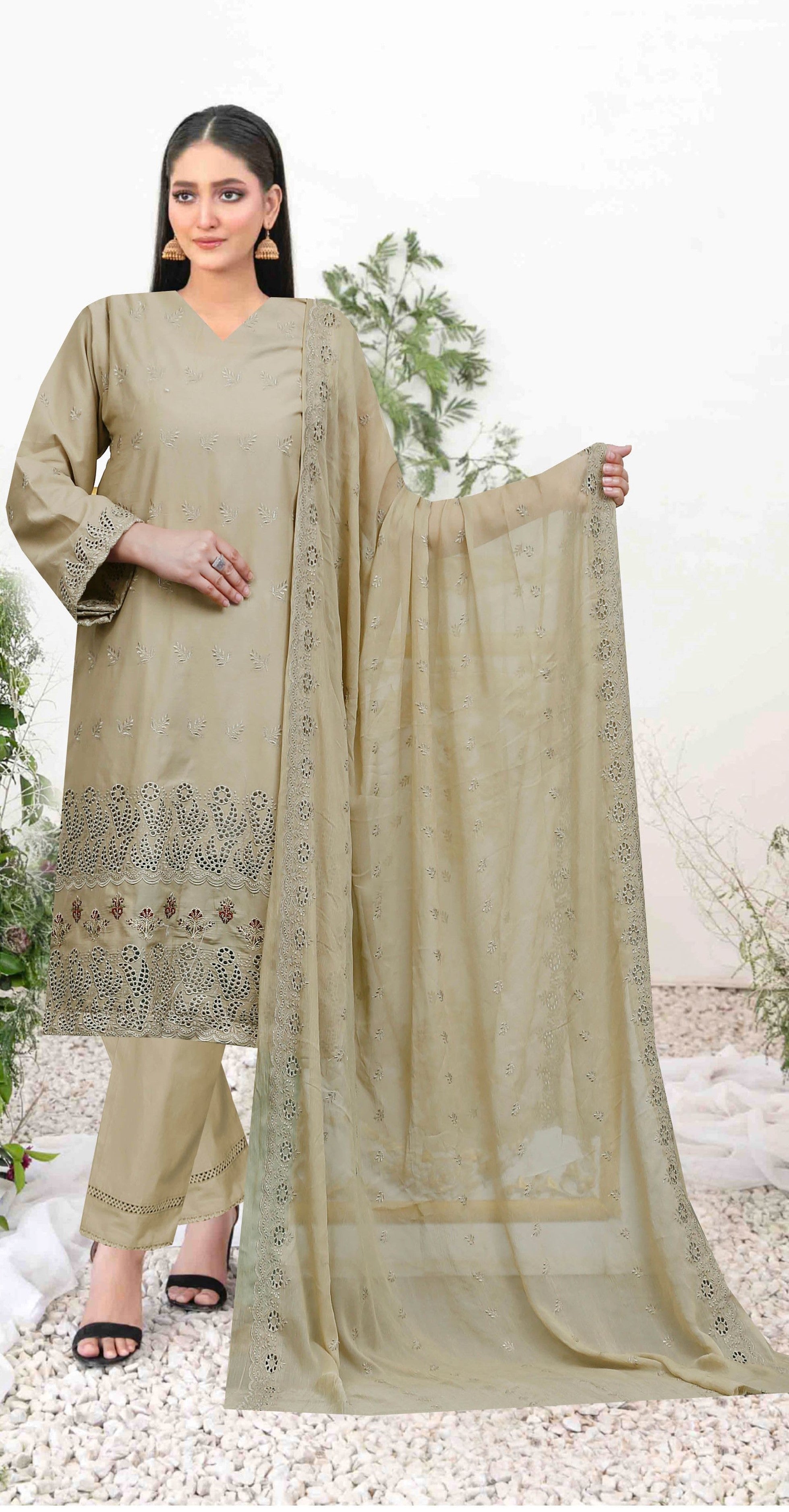 Woman wearing a beige traditional outfit with a matching dupatta outdoors.