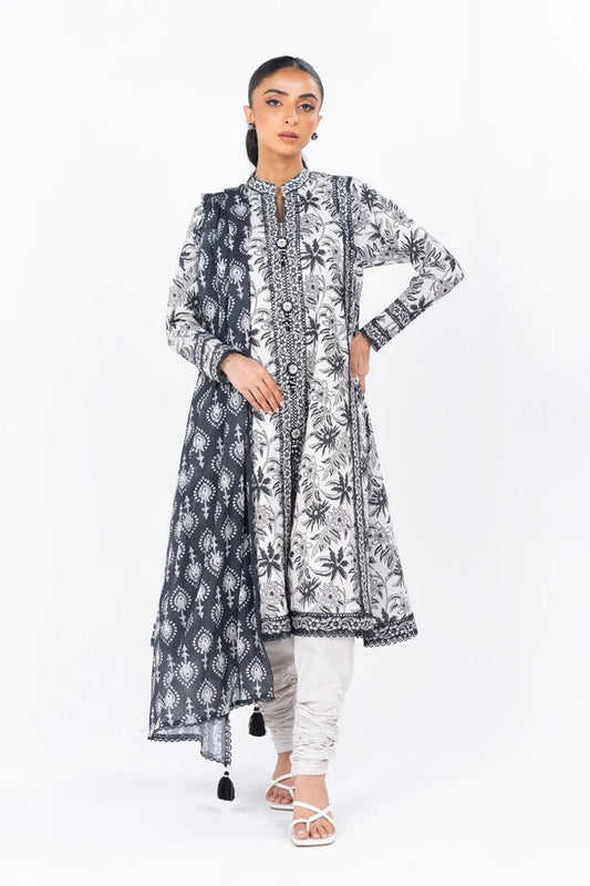 Woman wearing a black and white patterned kurta with dupatta on a white background