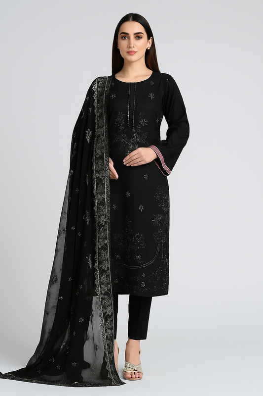 Woman wearing a black embroidered outfit with a matching dupatta on a white background