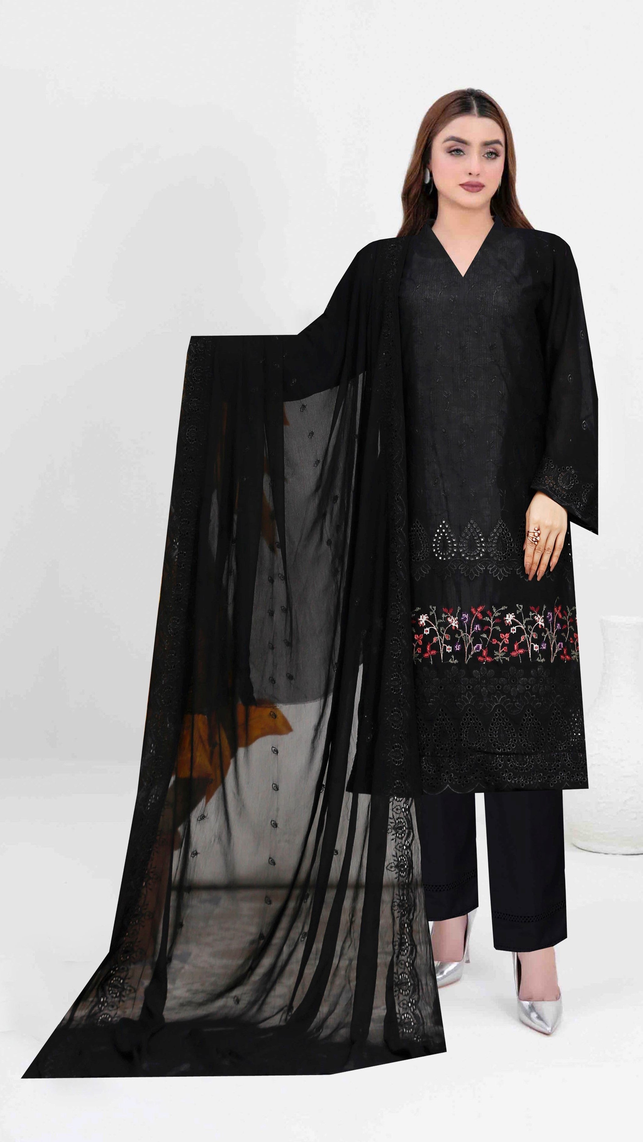 Woman wearing a black outfit with a sheer dupatta against a white background