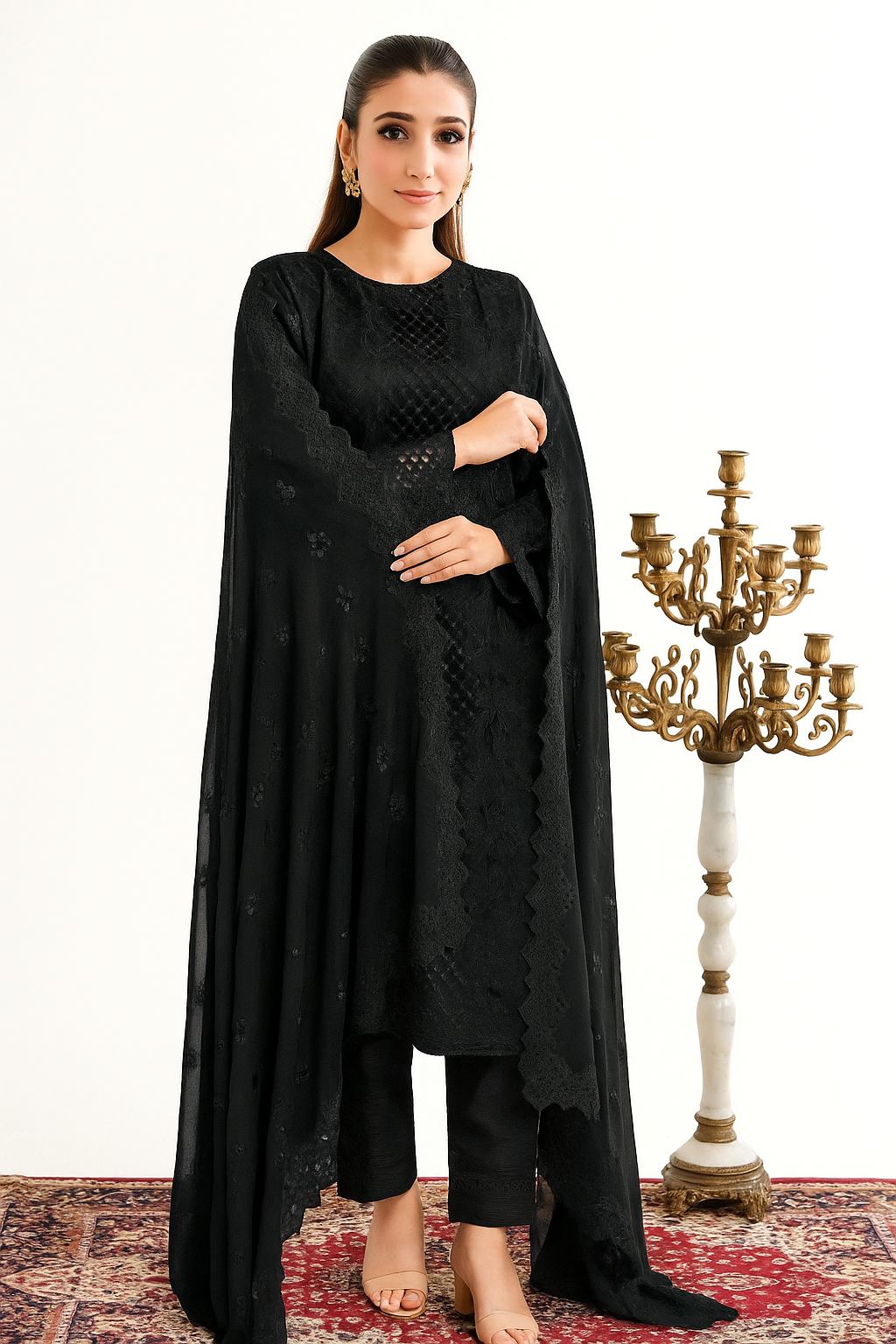 Woman wearing a black traditional outfit with a candelabra in the background