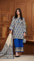 Woman wearing a blue and white patterned outfit with a matching dupatta in a wooden interior setting.