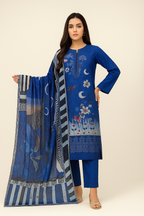 Woman wearing a blue embroidered outfit with a matching scarf on a white background