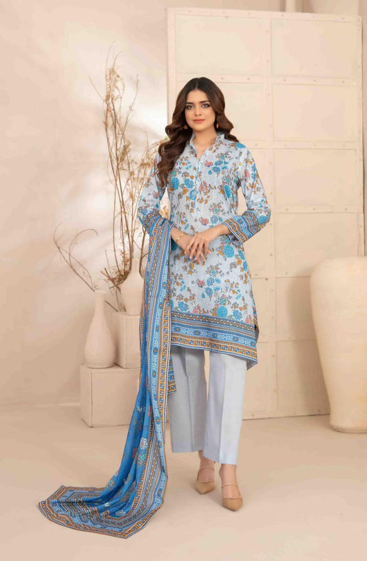 Woman wearing a blue floral dress with matching dupatta in a minimalistic setting