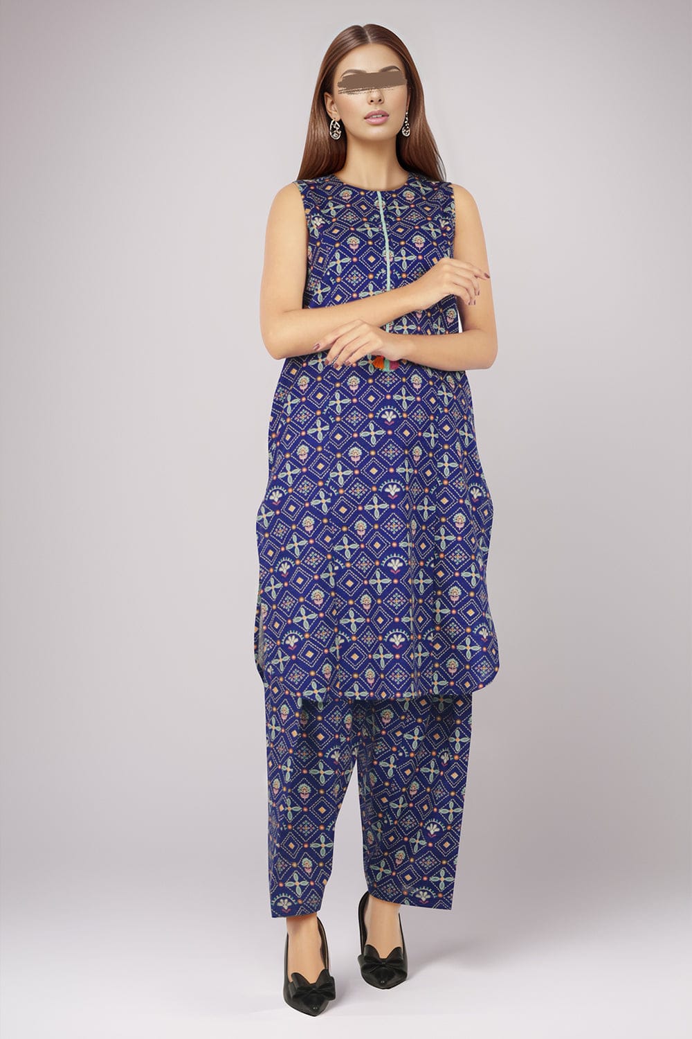 Woman wearing a blue patterned outfit on a white background