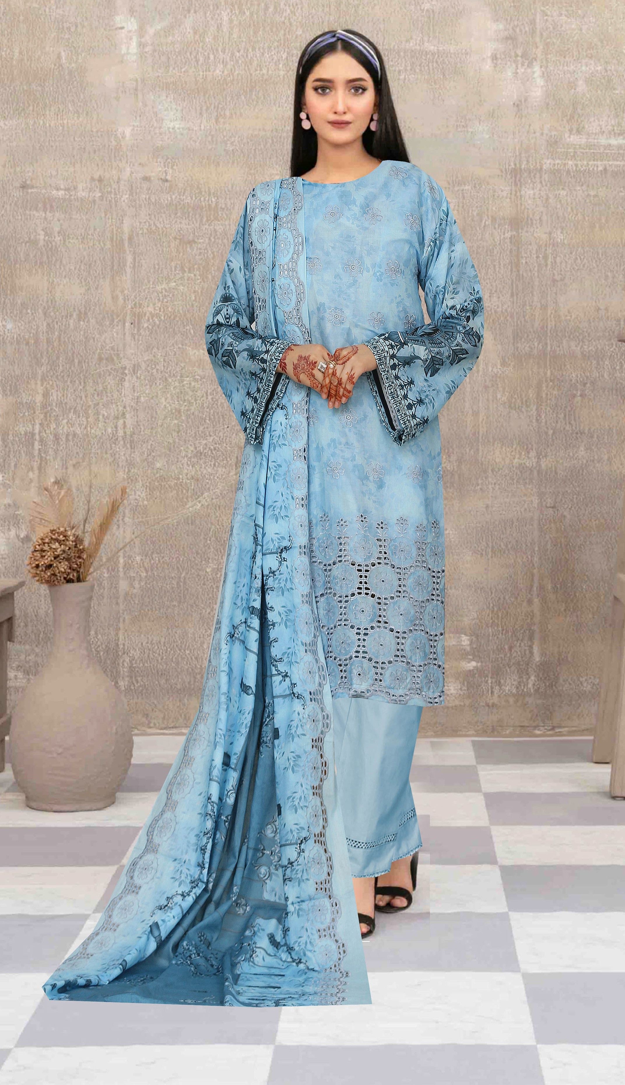 Woman wearing a blue traditional outfit with a checkered floor and neutral wall background