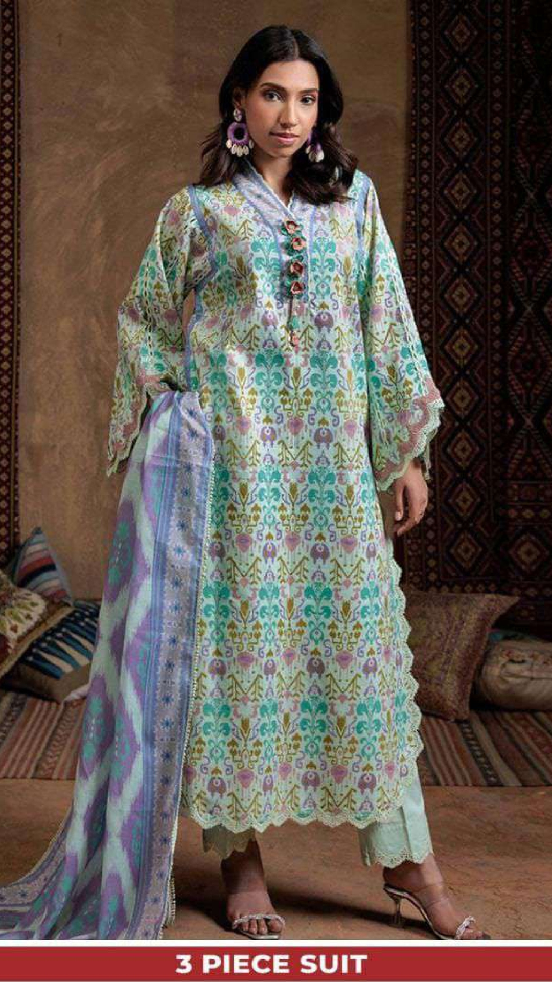 Woman wearing a bonanza   floral 3-piece suit in a decorated room.