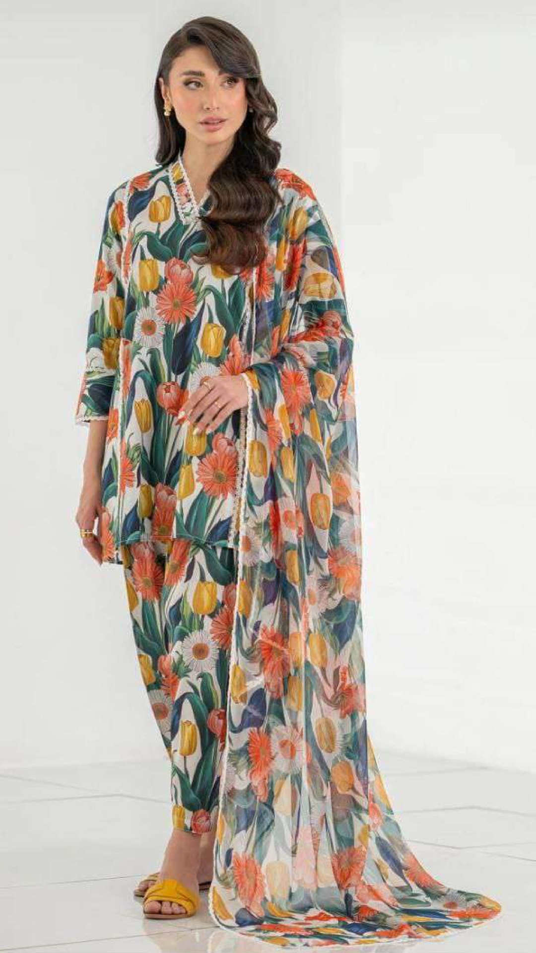 Woman wearing a colorful floral dress on a white background