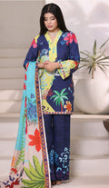 Woman wearing a colorful floral outfit with a patterned scarf indoors.