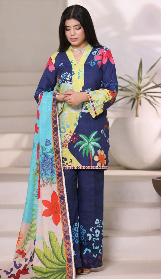 Woman wearing a colorful floral outfit with a patterned scarf indoors.