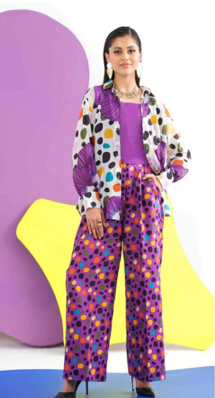 Woman wearing a colorful outfit with polka dot patterns against a vibrant background