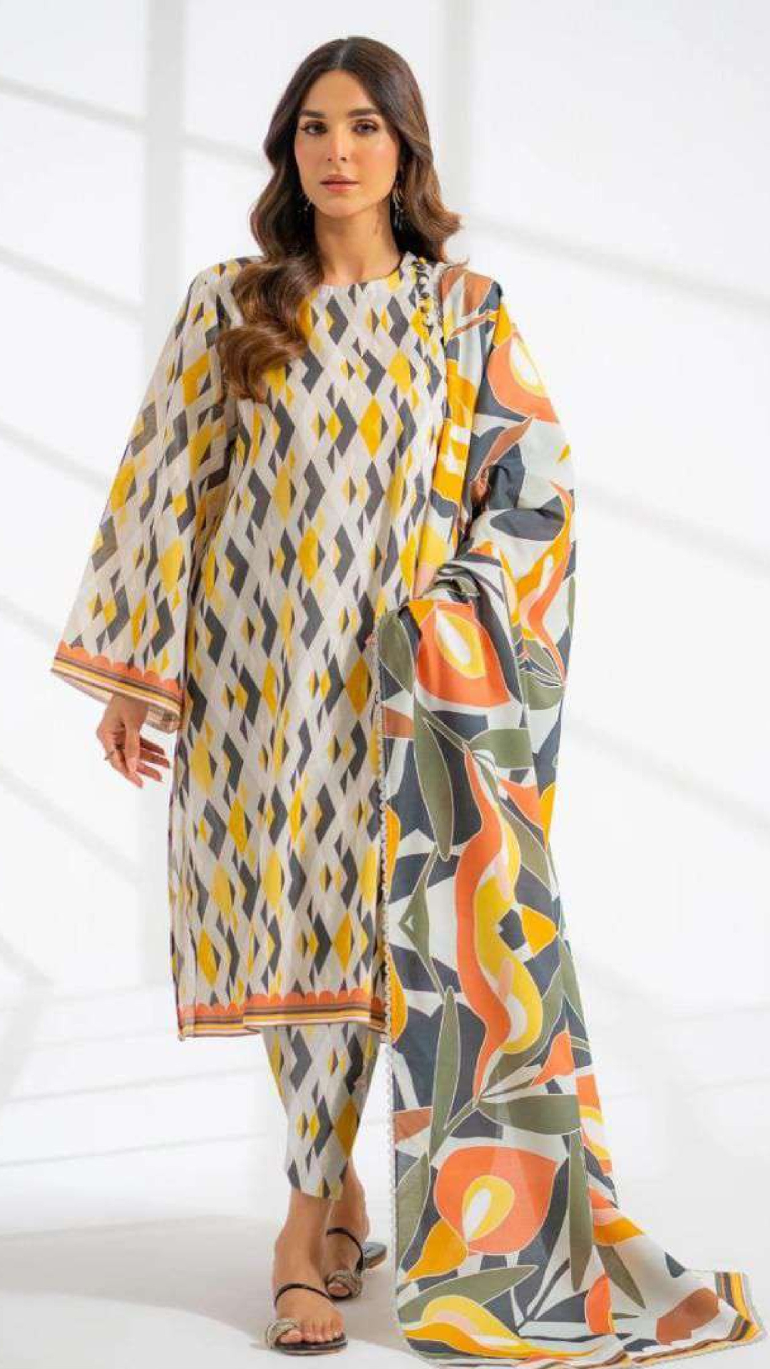 Woman wearing a colorful patterned outfit on a white background