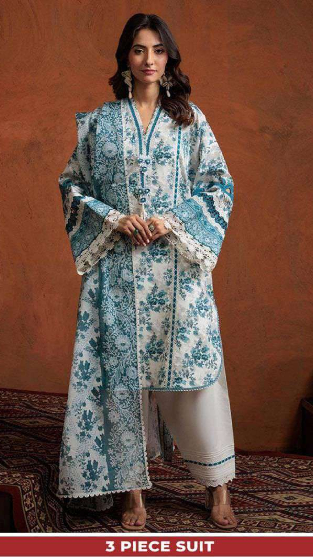 Woman wearing a floral 3-piece suit against a brown background