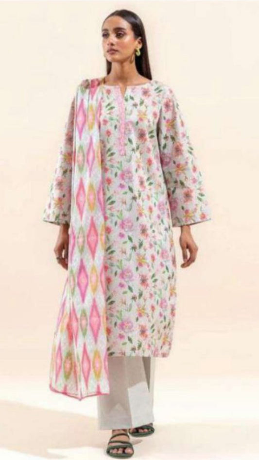 Woman wearing a floral and geometric patterned kurta with white pants on a beige background