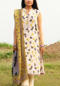 Woman wearing a floral dress with a yellow dupatta in an outdoor setting