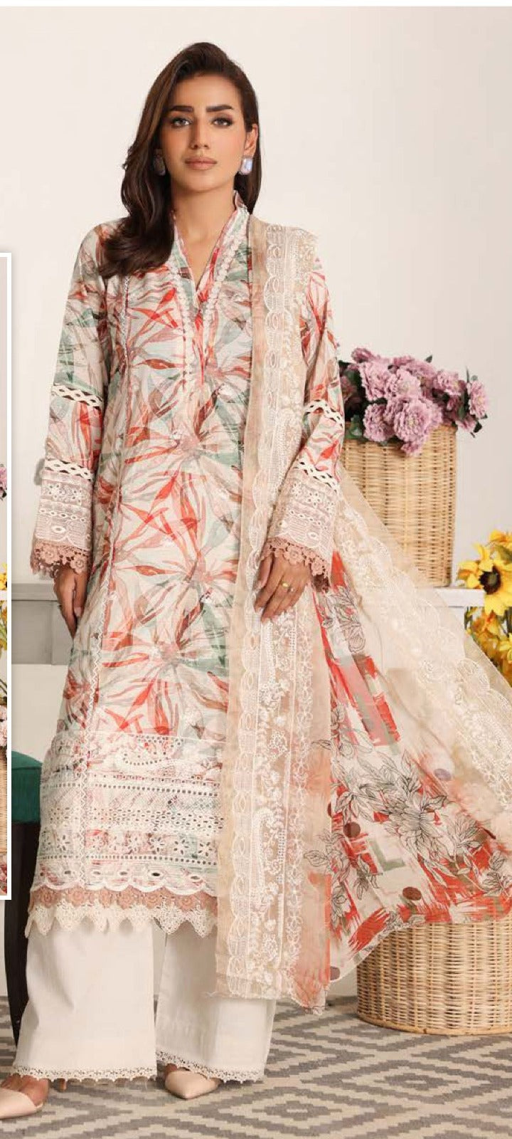 Woman wearing a floral embroidered outfit with a white background