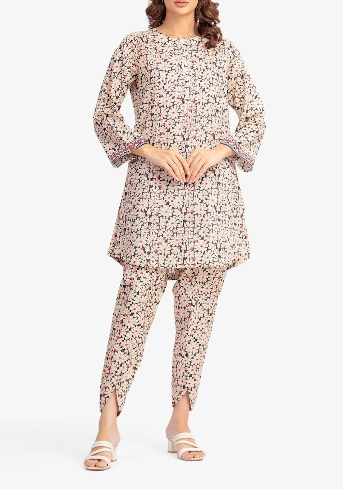Woman wearing a floral kurta and pants set on a white background