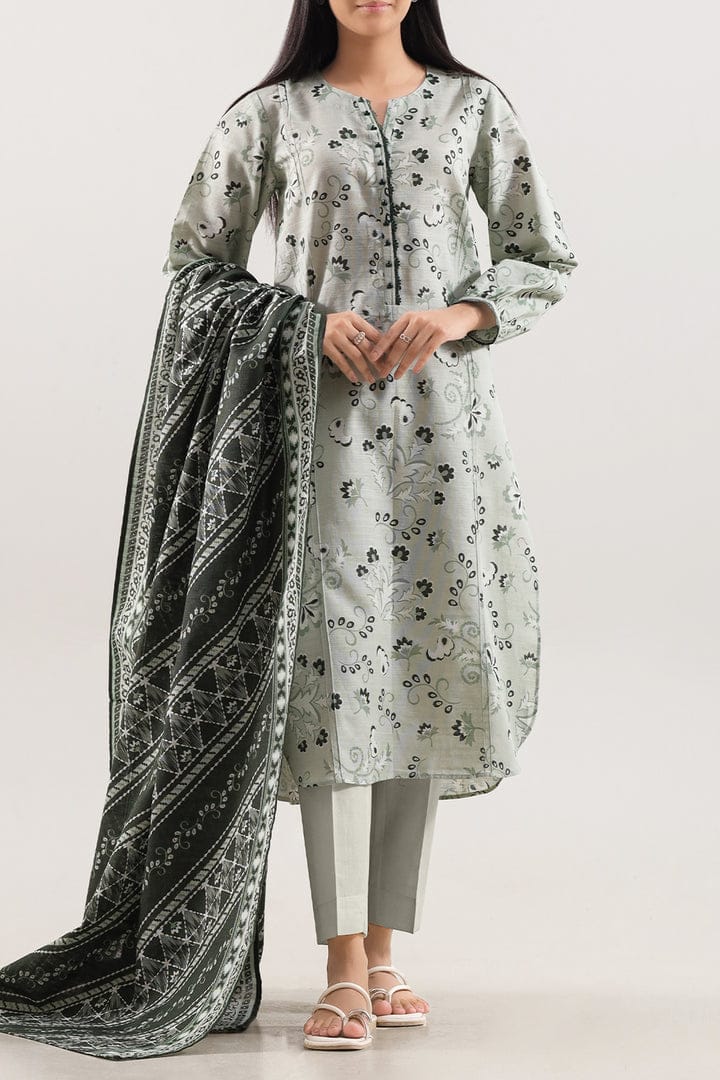 Woman wearing a floral kurta with a greenand black dupatta on a white background