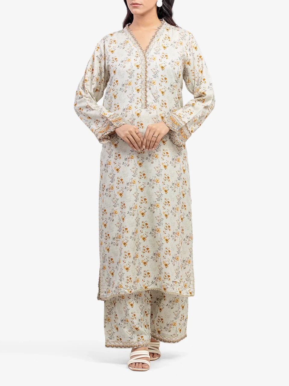 Woman wearing a floral kurta with palazzo pants on a white background