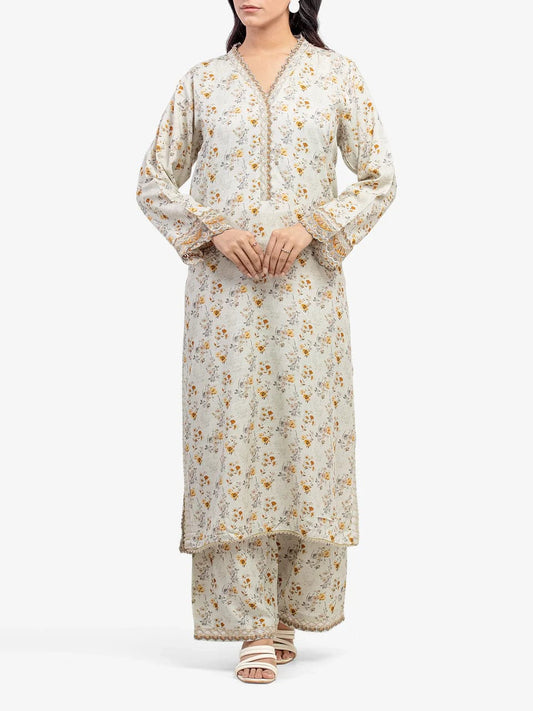 Woman wearing a floral kurta with palazzo pants on a white background