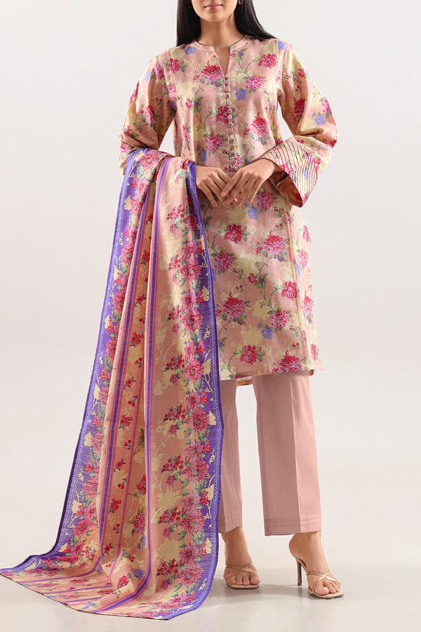 Woman wearing a floral kurta with pants and a matching dupatta on a white background