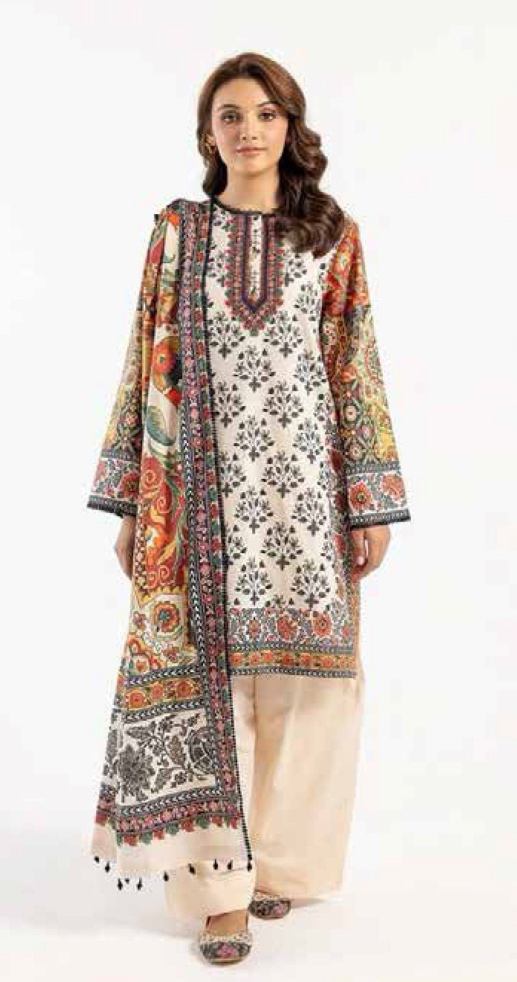 Woman wearing a floral printed kurta with a matching dupatta on a white background