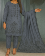 Woman wearing a gray embroidered outfit with a matching dupatta against a neutral background