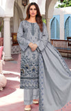 Woman wearing a gray embroidered traditional outfit with a dupatta in an outdoor setting.