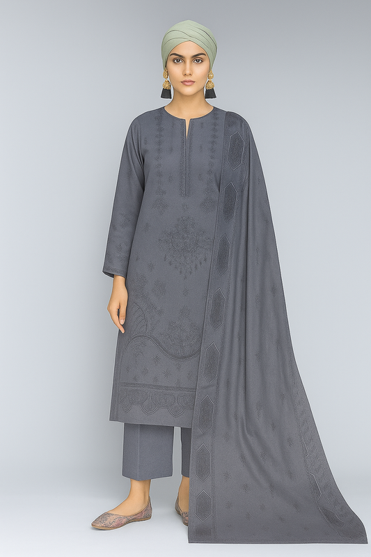 Woman wearing a gray traditional outfit with a matching dupatta on a light gray background