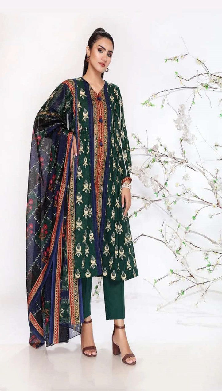 Woman wearing a green and navy traditional outfit with a matching dupatta on a white background