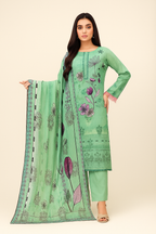 Woman wearing a green embroidered outfit with a matching dupatta on a beige background