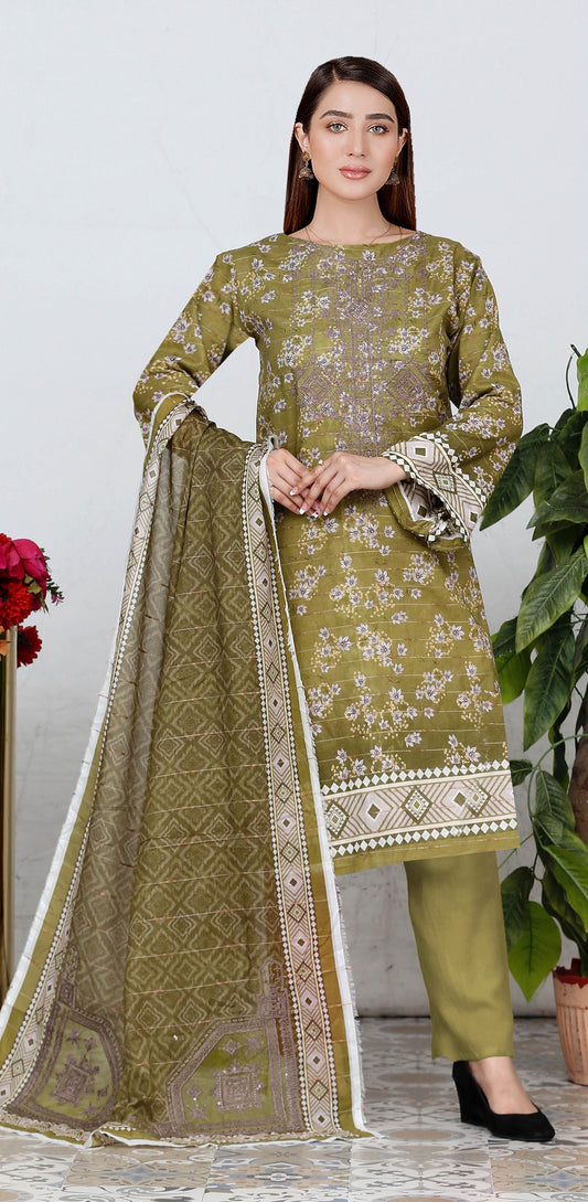 Woman wearing a green embroidered traditional outfit with a white dupatta.