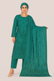 Woman wearing a green traditional outfit with a matching dupatta on a beige background