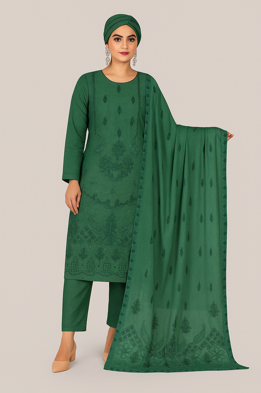 Woman wearing a green traditional outfit with a matching dupatta on a beige background