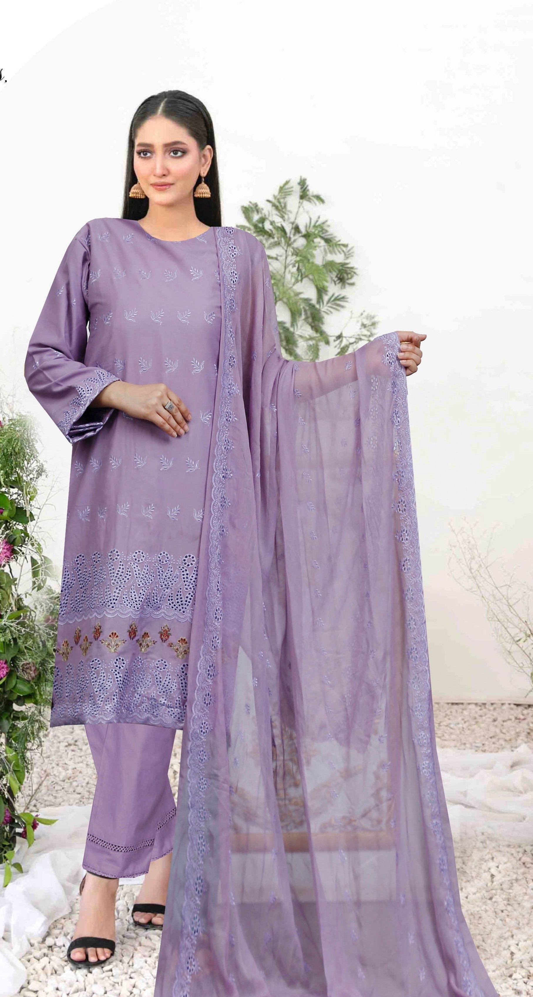 Woman wearing a lavender traditional outfit with a dupatta against a white background
