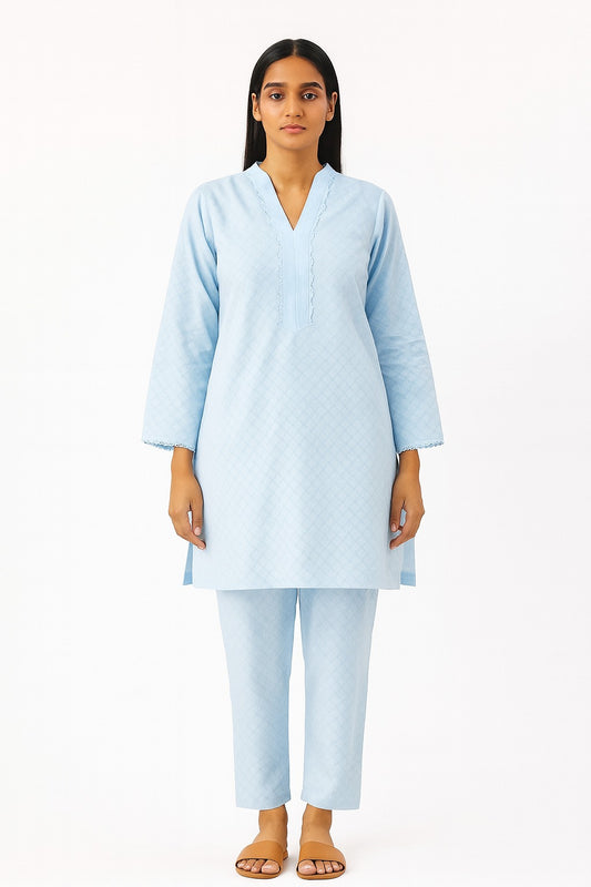 Woman wearing a light blue kurta with trouser on a white background