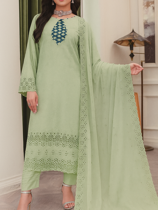 Woman wearing a light green embroidered outfit with a matching dupatta indoors.