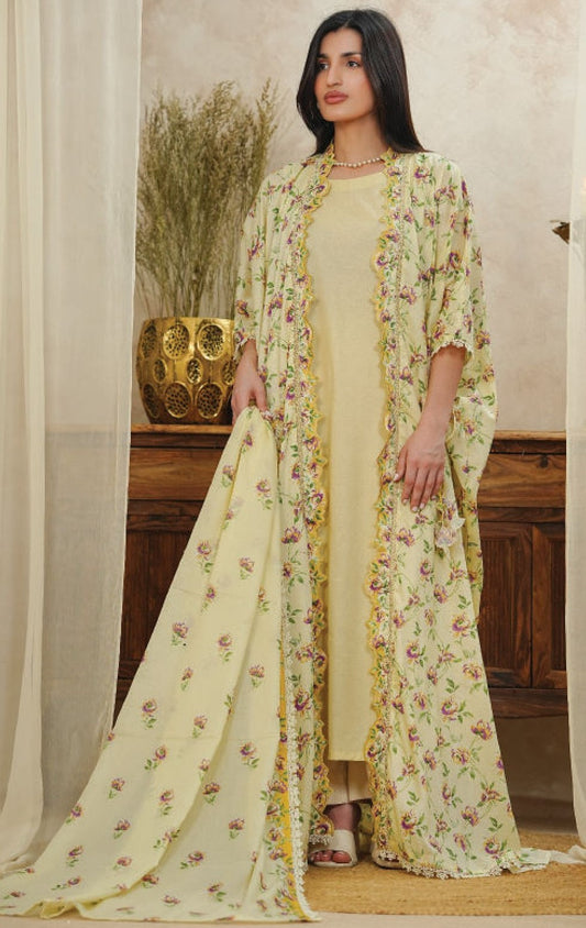 Woman wearing a light green floral outfit with a matching dupatta in a neutral setting.