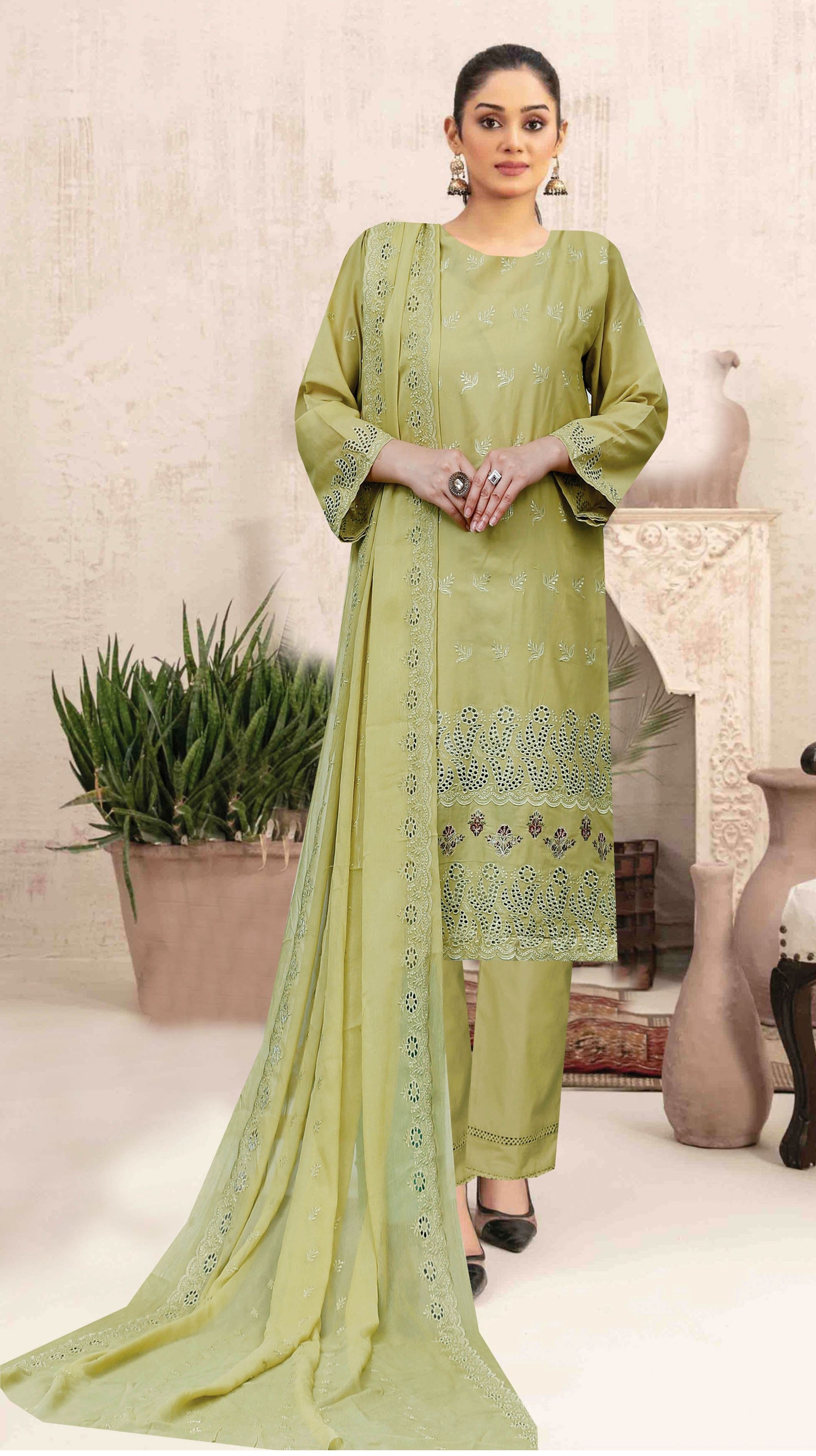 Woman wearing a light green traditional outfit with a matching dupatta in a minimal indoor setting.