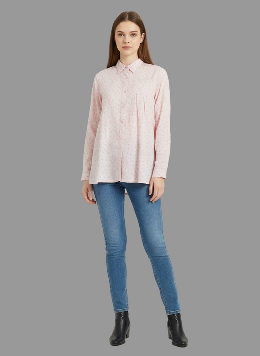 Woman wearing a light pink blouse and blue jeans on a gray background